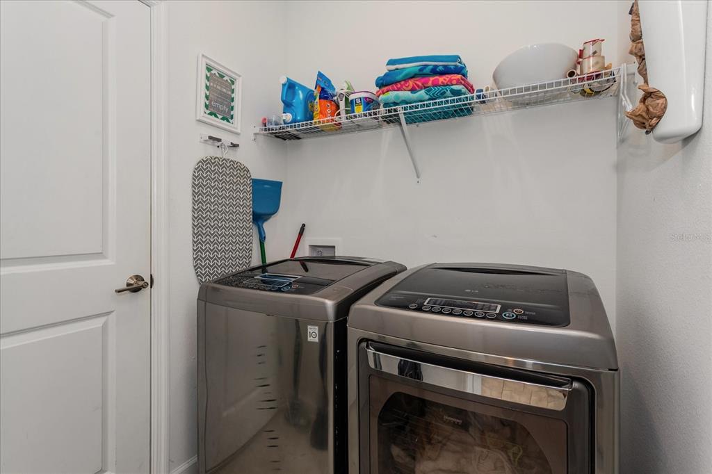 5616 Quiet Palm Loop St. Cloud, FL 34771 - Photo 7 of 25 a utility room with dryer and washer