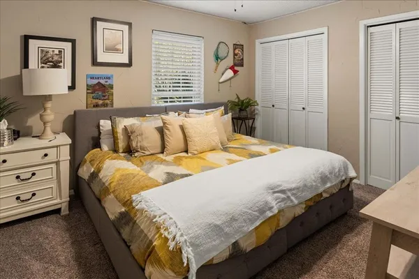 a large bed sitting in a bedroom next to a window