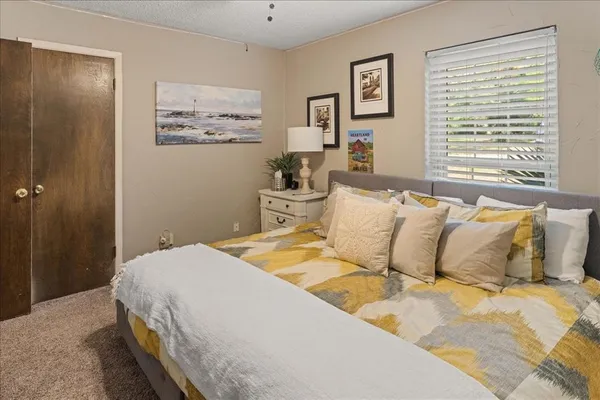 a bedroom with a large bed and a window