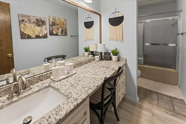 a bath room with a sink and a mirror