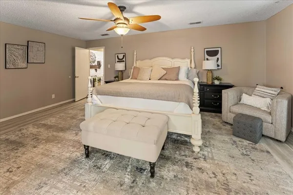 a bedroom with a bed and a chandelier