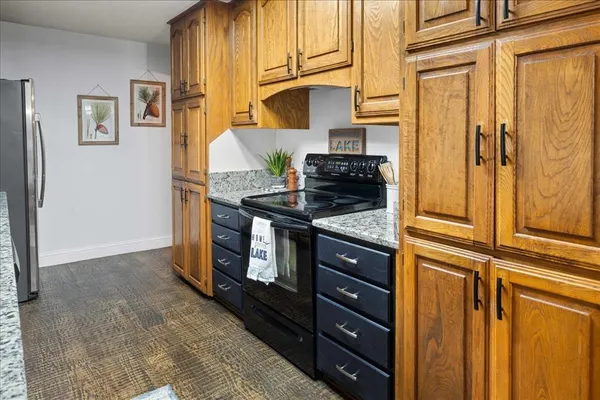a kitchen with stainless steel appliances granite countertop a refrigerator and a stove