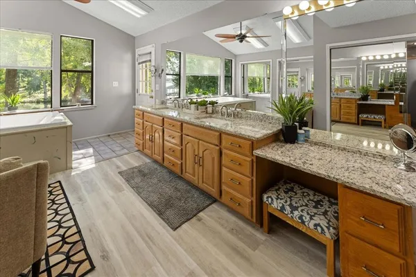 a bathroom with sink granite and a large mirror