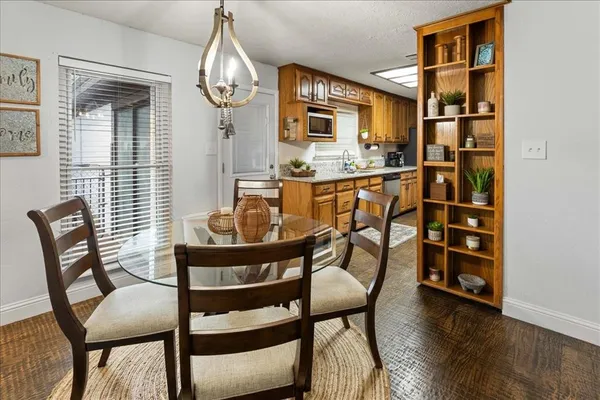 a dining room with furniture and wooden floor
