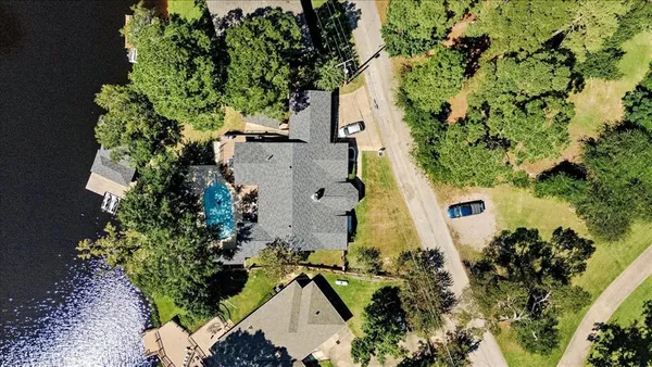 an aerial view of a house with a yard and garden