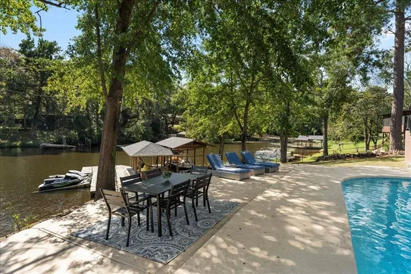 a view of a patio with a table and chairs under an umbrella