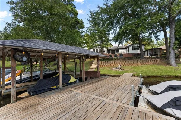 an outdoor space with wooden seating and swimming pool
