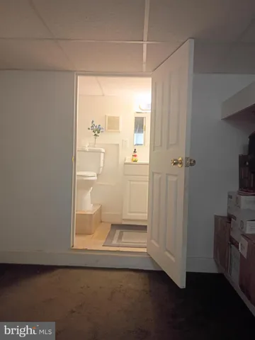 a view of a small space with wooden floor and a window