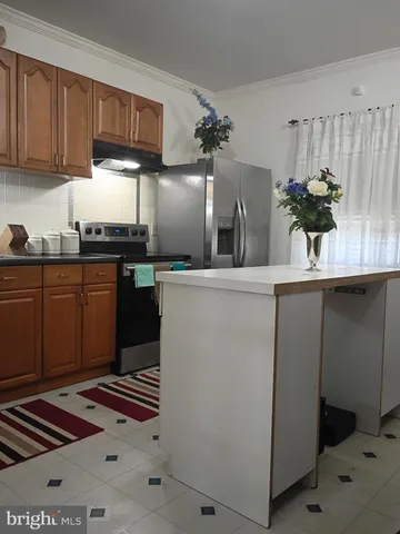 a kitchen with stainless steel appliances granite countertop a sink a stove and a refrigerator