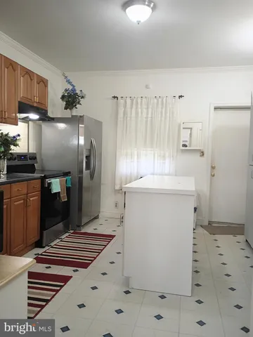 a kitchen with stainless steel appliances a refrigerator and a stove