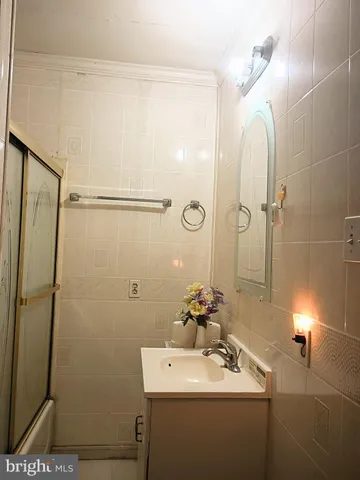 a bathroom with a sink a mirror and shower