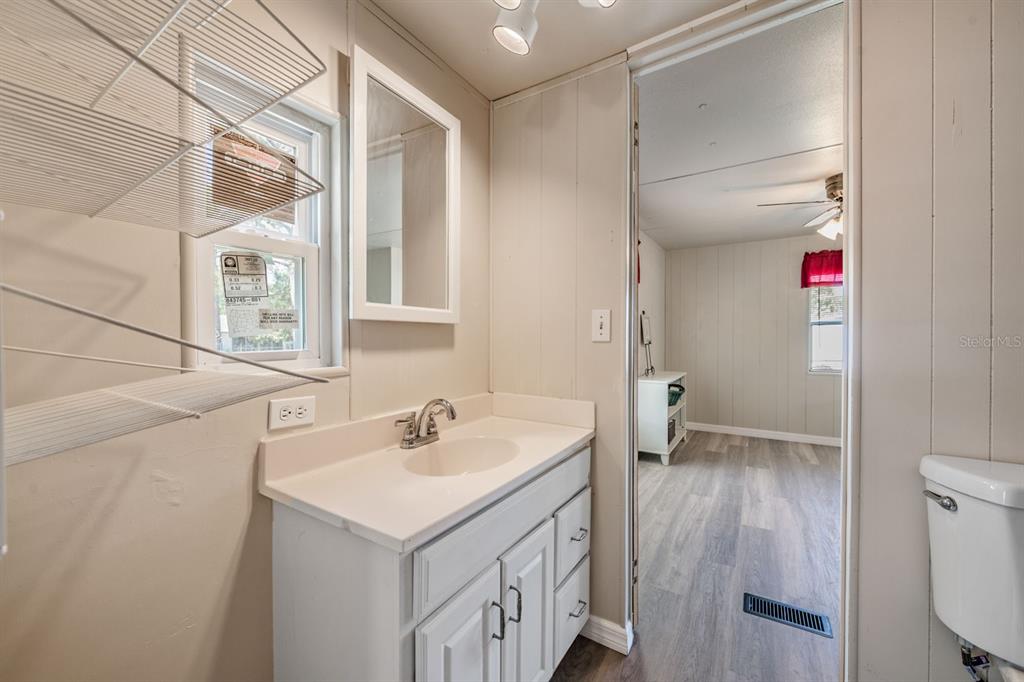 9739 Ray Street Hudson, FL 34669 - Photo 28 of 36 a bathroom with a sink and a mirror