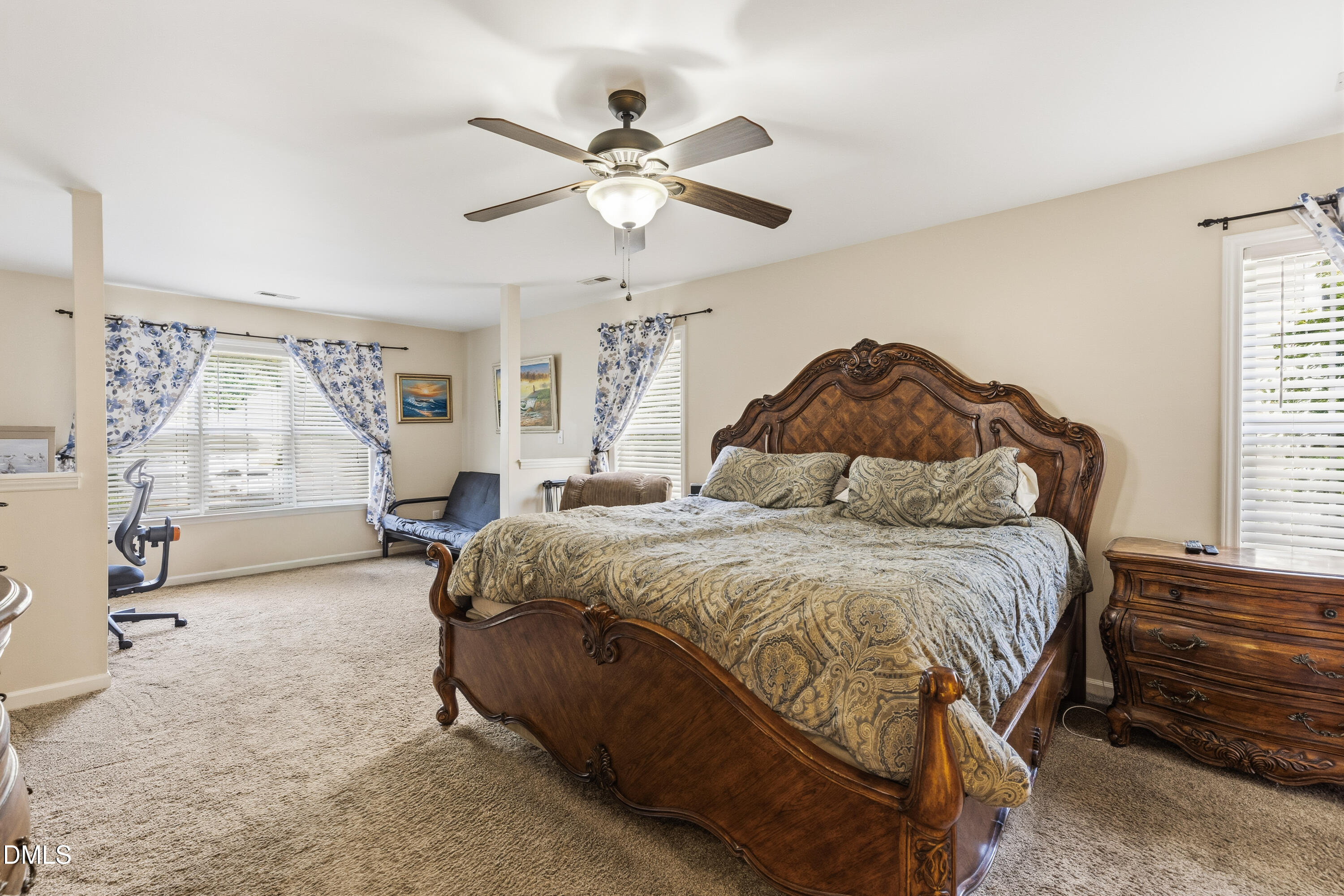 352 Arbor Crest Road Holly Springs, NC 27540 - Photo 22 of 36 a bedroom with a bed and a chandelier