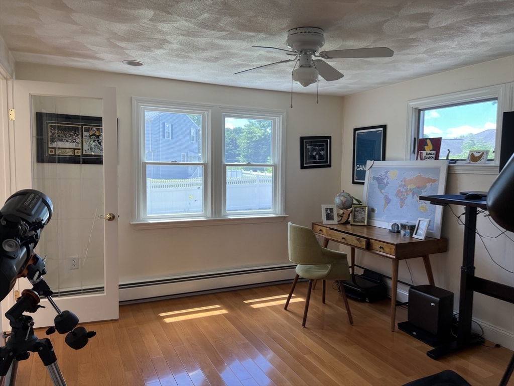 11 Garrison Road, Unit 1 Arlington, MA 02474 - Photo 19 of 42 a view of a workspace with furniture and a window