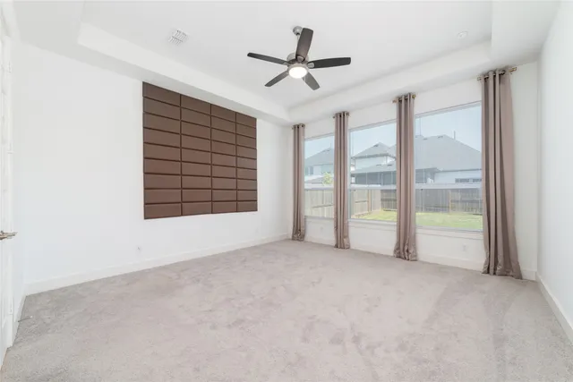 a large white kitchen with a sink and dishwasher a stove top oven with wooden floor