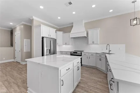 a kitchen with stainless steel appliances a sink stove and refrigerator