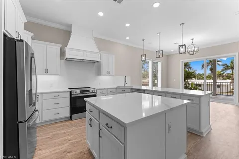 a kitchen with granite countertop a sink stove and refrigerator