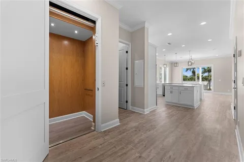 a view of a kitchen with wooden floor and a sink