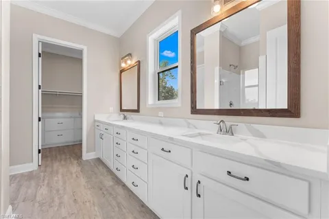 a bathroom with double sink and a mirror