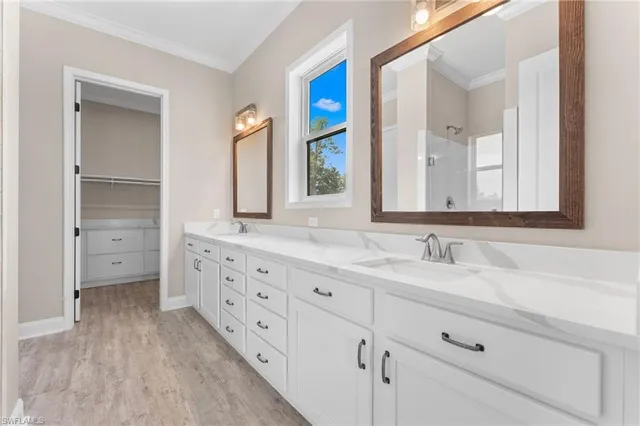 a bathroom with double sink and a mirror