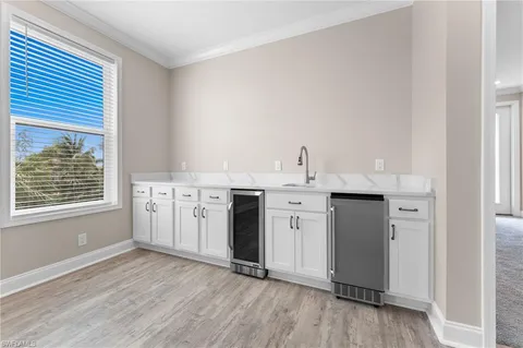 a kitchen with stainless steel appliances a white stove top oven cabinets and a wooden floor