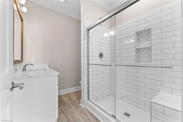 a bathroom with a shower and a sink
