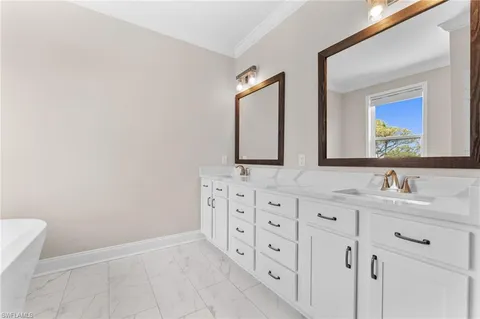 a bathroom with double sink and a mirror