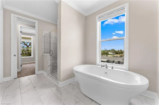 a white bath tub sitting next to a white sink
