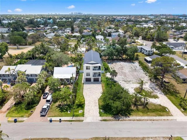 an aerial view of a house with a yard and lake view