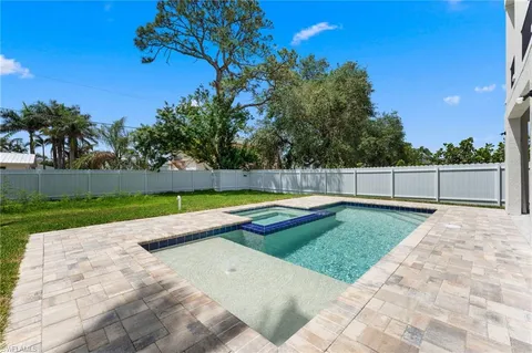 a view of a backyard with swimming pool
