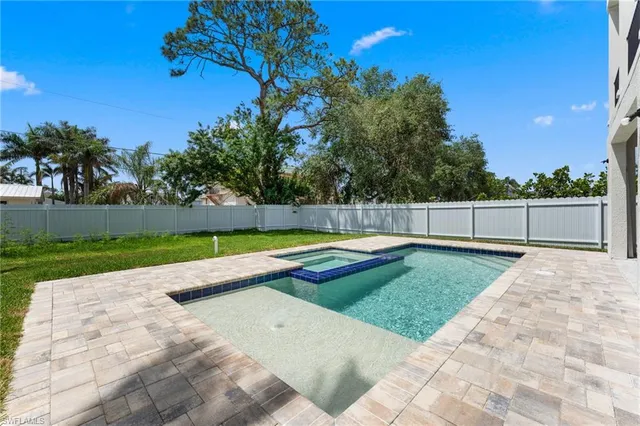 a view of a backyard with swimming pool