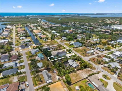 an aerial view of residential building with outdoor space and ocean view