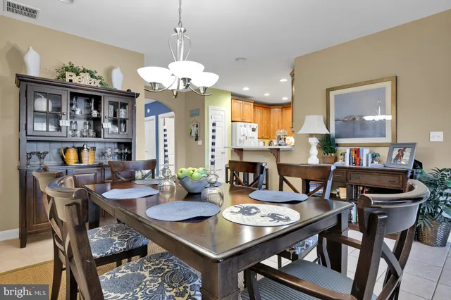 a view of a dining room with furniture and a chandelier