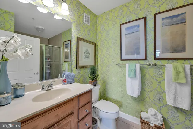 a bathroom with a sink vanity mirror and toilet