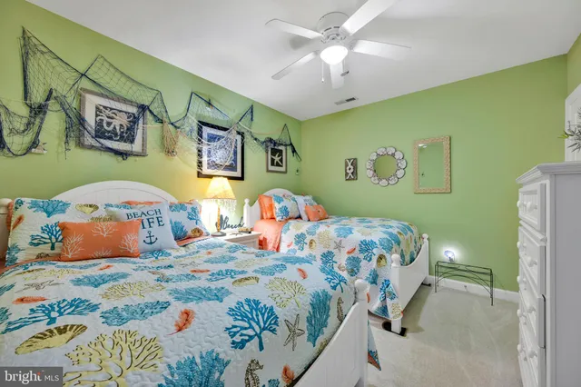 a bedroom with a bed and ceiling fan