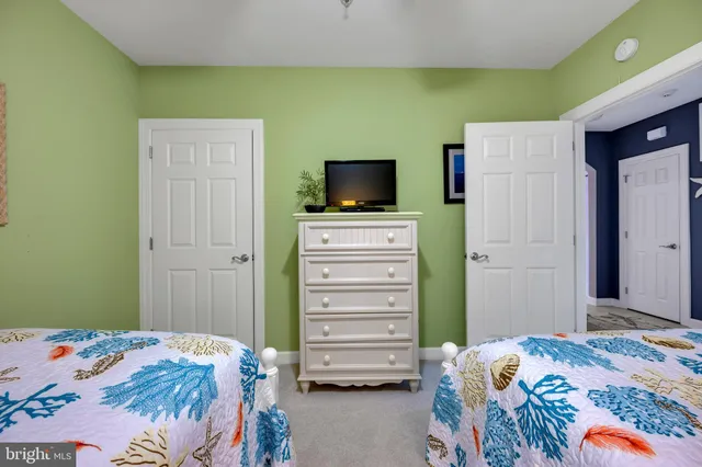 a bedroom with a bed and flat screen tv
