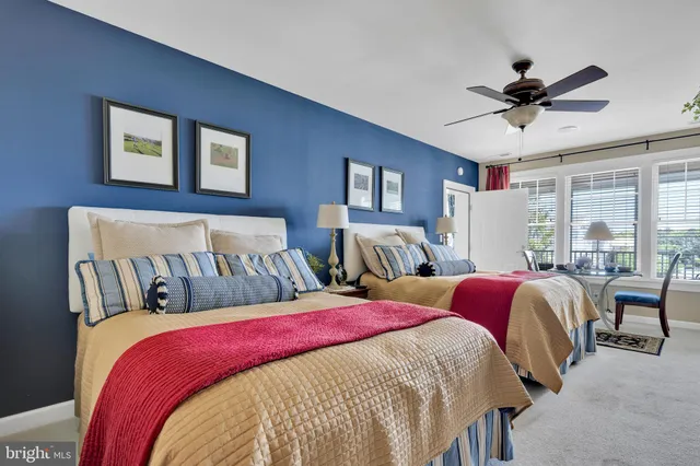 a bed room with two bed and a window