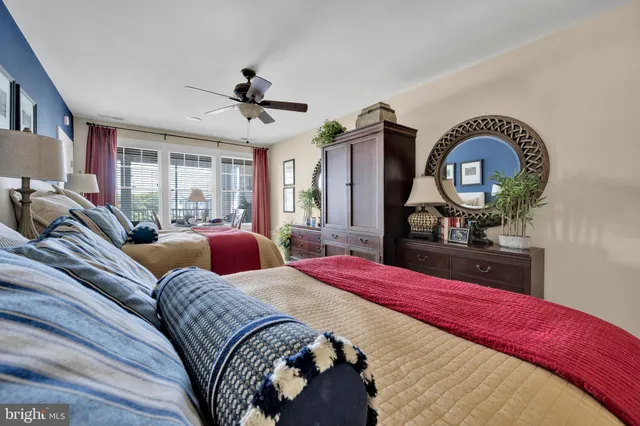 a bedroom with a bed and a dresser with mirror