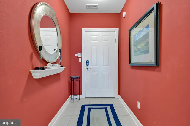 a view of a room with wooden floor and white wall