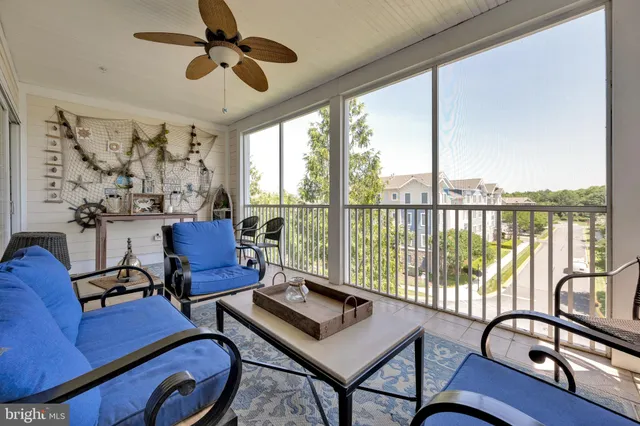 a living room with furniture and a floor to ceiling window