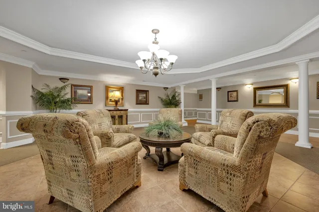 a living room with furniture and a chandelier