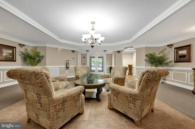 a living room with furniture and a chandelier