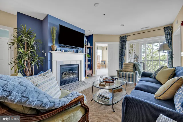 a living room with furniture fireplace and flat screen tv