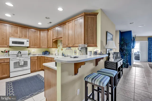 a kitchen with stainless steel appliances kitchen island granite countertop a sink and cabinets