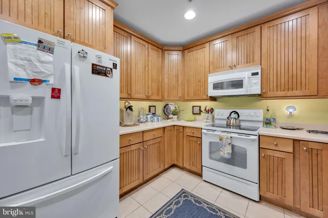 a kitchen with stainless steel appliances granite countertop a refrigerator sink and cabinets