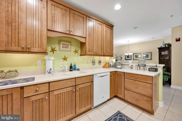 a kitchen with kitchen island granite countertop a sink window and cabinets