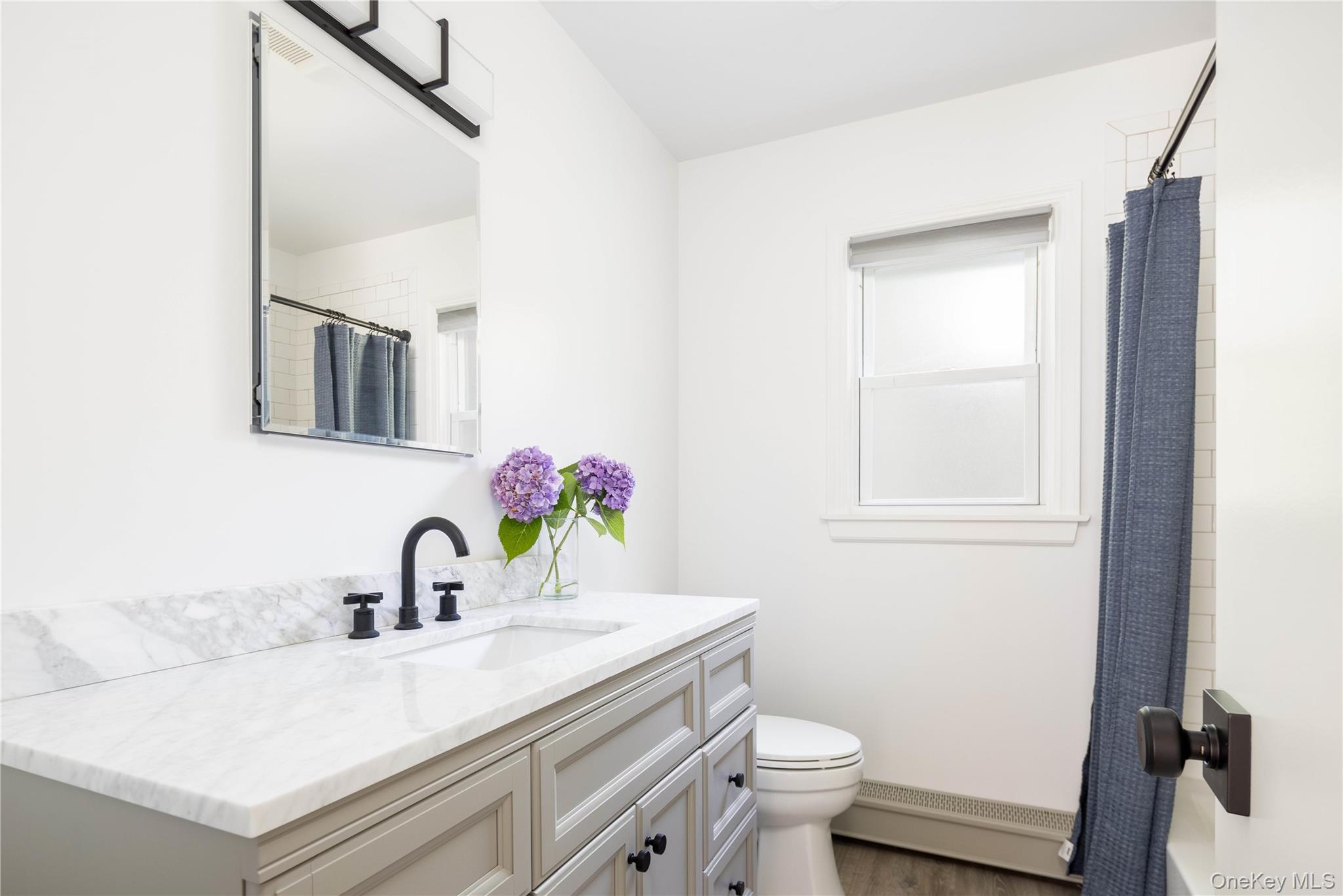 795 Pine Tree Road Cutchogue, NY 11935 - Photo 9 of 18 a bathroom with a sink toilet and mirror