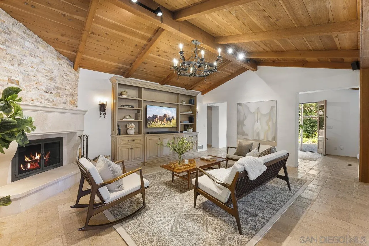 6101 Camino Selva Rancho Santa Fe, CA 92067 - Photo 14 of 35 a living room with furniture a fireplace and a chandelier