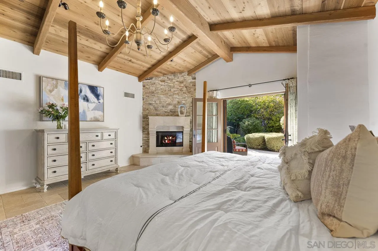 6101 Camino Selva Rancho Santa Fe, CA 92067 - Photo 18 of 35 a large bed sitting in a bedroom next to a window with a flat tv screen