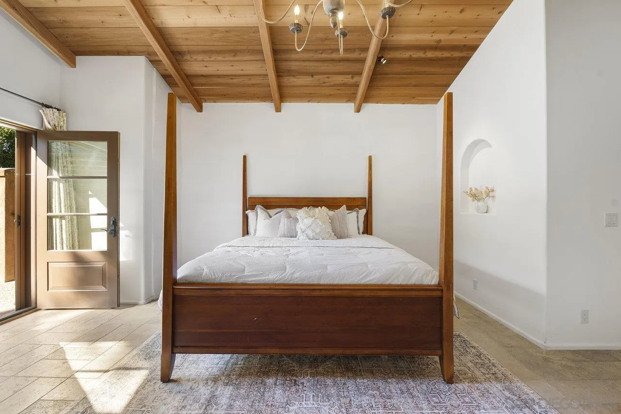 6101 Camino Selva Rancho Santa Fe, CA 92067 - Photo 19 of 35 a bedroom with a bed and wooden floor